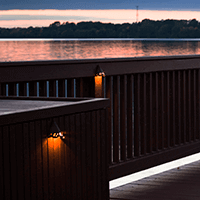Deck lights with a sunset behind